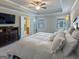 Bright bedroom features a tray ceiling, carpeted floor, a view of the bathroom, and a bed at 360 Hayden Cir, Woodstock, GA 30189