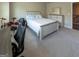 Bright bedroom features a whitewashed wood bed frame, dresser, and a carpeted floor at 360 Hayden Cir, Woodstock, GA 30189