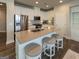 Open kitchen features stainless steel appliances, white cabinets, and a breakfast bar with seating at 360 Hayden Cir, Woodstock, GA 30189
