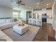 Open living area features hardwood floors, a fireplace, and a view of the modern kitchen at 360 Hayden Cir, Woodstock, GA 30189