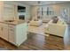 Bright open floor plan featuring hardwood floors, a fireplace, and a view of the kitchen at 360 Hayden Cir, Woodstock, GA 30189