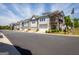 Street view of charming townhomes with garages and attractive landscaping on a sunny day at 360 Hayden Cir, Woodstock, GA 30189