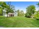 The large backyard has lush green grass and a treed boundary, perfect for relaxation at 8091 Bouldercrest Pl, Douglasville, GA 30135