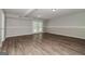 Unfinished basement with wood floors, neutral paint, and walkout doors to the backyard at 8091 Bouldercrest Pl, Douglasville, GA 30135