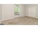 Carpeted bedroom with a closet and a window with bright natural light at 8091 Bouldercrest Pl, Douglasville, GA 30135