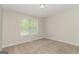 Bright bedroom with carpet floors, and a single window for natural light at 8091 Bouldercrest Pl, Douglasville, GA 30135