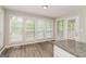 Sunlit breakfast nook with granite counters, wood floors, and multiple windows offering lovely outdoor views at 8091 Bouldercrest Pl, Douglasville, GA 30135