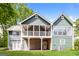 Exterior of the home features a walk out basement and large porch on the upper level at 8091 Bouldercrest Pl, Douglasville, GA 30135