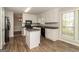 Well-lit kitchen with white cabinets, black appliances, and granite countertops, perfect for cooking and entertaining at 8091 Bouldercrest Pl, Douglasville, GA 30135