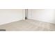 Bedroom with neutral carpet, white walls, a white door, white trim, and visible electrical outlets at 236 Oliver Dr, Locust Grove, GA 30248
