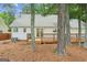 Wide backyard with access to home via deck and sliding glass doors at 3979 Doral Cir, Atlanta, GA 30360