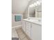 Bathroom featuring double sinks, white cabinets, and a tile floor at 3979 Doral Cir, Atlanta, GA 30360