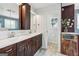 Bathroom with white double sinks and dark wood cabinets at 3979 Doral Cir, Atlanta, GA 30360