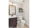 Bathroom featuring a dark vanity, a toilet, and decor shelving at 3979 Doral Cir, Atlanta, GA 30360