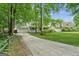 Suburban home featuring a wide driveway, attached garage, and a neatly kept front lawn at 3979 Doral Cir, Atlanta, GA 30360