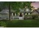 Charming home featuring a welcoming front porch, manicured lawn, and a beautiful red door at 3979 Doral Cir, Atlanta, GA 30360