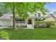 Charming home with a welcoming front porch, a vibrant red door, and well-manicured lawn at 3979 Doral Cir, Atlanta, GA 30360
