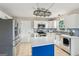 Bright kitchen with white cabinets, stainless steel appliances, and a blue island at 3979 Doral Cir, Atlanta, GA 30360