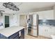 Bright kitchen with white cabinets, stainless steel appliances, and blue island at 3979 Doral Cir, Atlanta, GA 30360