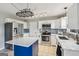 Bright kitchen featuring white cabinets, stainless steel appliances, and a stylish blue island at 3979 Doral Cir, Atlanta, GA 30360