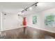 Bright living room featuring hardwood floors, a window, and a red door at 3979 Doral Cir, Atlanta, GA 30360