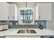 The kitchen features a stainless steel sink and a bright window at 3979 Doral Cir, Atlanta, GA 30360