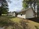 Spacious backyard features lush green grass and mature trees providing ample shade and privacy at 130 Elm St, Hampton, GA 30228