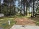 A large backyard with a wood deck and a backdrop of mature trees, perfect for outdoor activities and gatherings at 130 Elm St, Hampton, GA 30228
