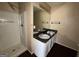 Bathroom featuring double sink vanity and shower at 130 Elm St, Hampton, GA 30228