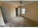 Neutral bedroom with a ceiling fan, natural light, and carpeted floors at 130 Elm St, Hampton, GA 30228