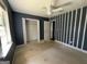 Bedroom with a ceiling fan, closet, and window at 130 Elm St, Hampton, GA 30228