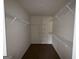 Walk-in closet with white shelving and carpeted floors at 130 Elm St, Hampton, GA 30228