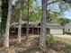 Charming brick ranch home with a two-car garage and a well-manicured front yard shaded by mature trees at 130 Elm St, Hampton, GA 30228