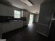 Modern kitchen with stainless steel appliances, white cabinets, and dark wood floors at 130 Elm St, Hampton, GA 30228