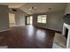 Inviting living room featuring hardwood floors, a cozy fireplace, and large windows that fill the space with light at 130 Elm St, Hampton, GA 30228