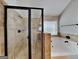 Spa-like bathroom featuring a glass-enclosed shower and a jetted bathtub by a window at 305 Mango Ct, Mcdonough, GA 30253
