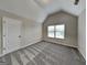 Bright bedroom with vaulted ceiling, large window, and neutral color palette at 305 Mango Ct, Mcdonough, GA 30253
