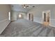 Large bonus room with wall-to-wall carpet and multiple windows for natural light at 305 Mango Ct, Mcdonough, GA 30253