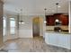 Open kitchen and dining area with updated appliances, granite counters, and hardwood style floors at 305 Mango Ct, Mcdonough, GA 30253