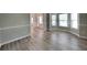 Open-concept living space showcasing luxury vinyl plank floors and large windows at 305 Mango Ct, Mcdonough, GA 30253