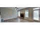 Cozy living room featuring luxury vinyl plank floors, a stone fireplace, and access to the backyard at 305 Mango Ct, Mcdonough, GA 30253
