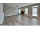 Open living area with hardwood-style floors, fireplace, and lots of natural light at 305 Mango Ct, Mcdonough, GA 30253