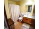 Bright bathroom features a vanity, toilet, and shower with curtain at 644 Garden Grove Dr, Lawrenceville, GA 30044