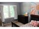 Bedroom with neutral wall color, dark wooden furniture, and a large window illuminating the space at 644 Garden Grove Dr, Lawrenceville, GA 30044