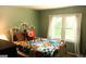 Bright bedroom featuring a decorative metal frame bed, soft colors, and a large window allowing for natural light at 644 Garden Grove Dr, Lawrenceville, GA 30044