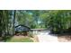 Suburban home with a well-manicured lawn, mature trees, and a two-car garage, creating a welcoming and picturesque setting at 644 Garden Grove Dr, Lawrenceville, GA 30044
