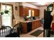 Functional kitchen featuring wooden cabinets, black appliances, and a cozy dining area, perfect for everyday meals at 644 Garden Grove Dr, Lawrenceville, GA 30044