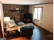 Cozy living room with brick fireplace, brick accent wall, and comfortable seating at 644 Garden Grove Dr, Lawrenceville, GA 30044