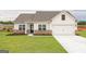 Beautiful one story home with white siding, brick accents, and a well manicured lawn at 239 Oliver Dr, Locust Grove, GA 30248