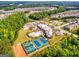 Aerial view of community amenities featuring pool, tennis courts, clubhouse, and surrounding homes at 444 Silverbell Ct, Peachtree City, GA 30269